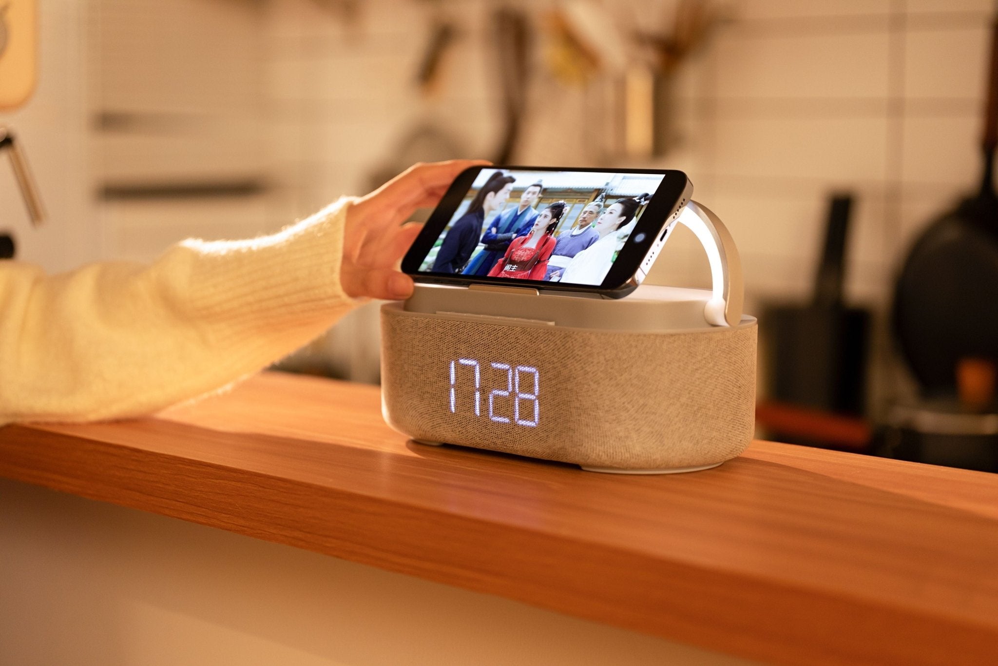 UK Technology Clock Radio Handle Lamp on a desk with a phone playing a video using the phone holding feature