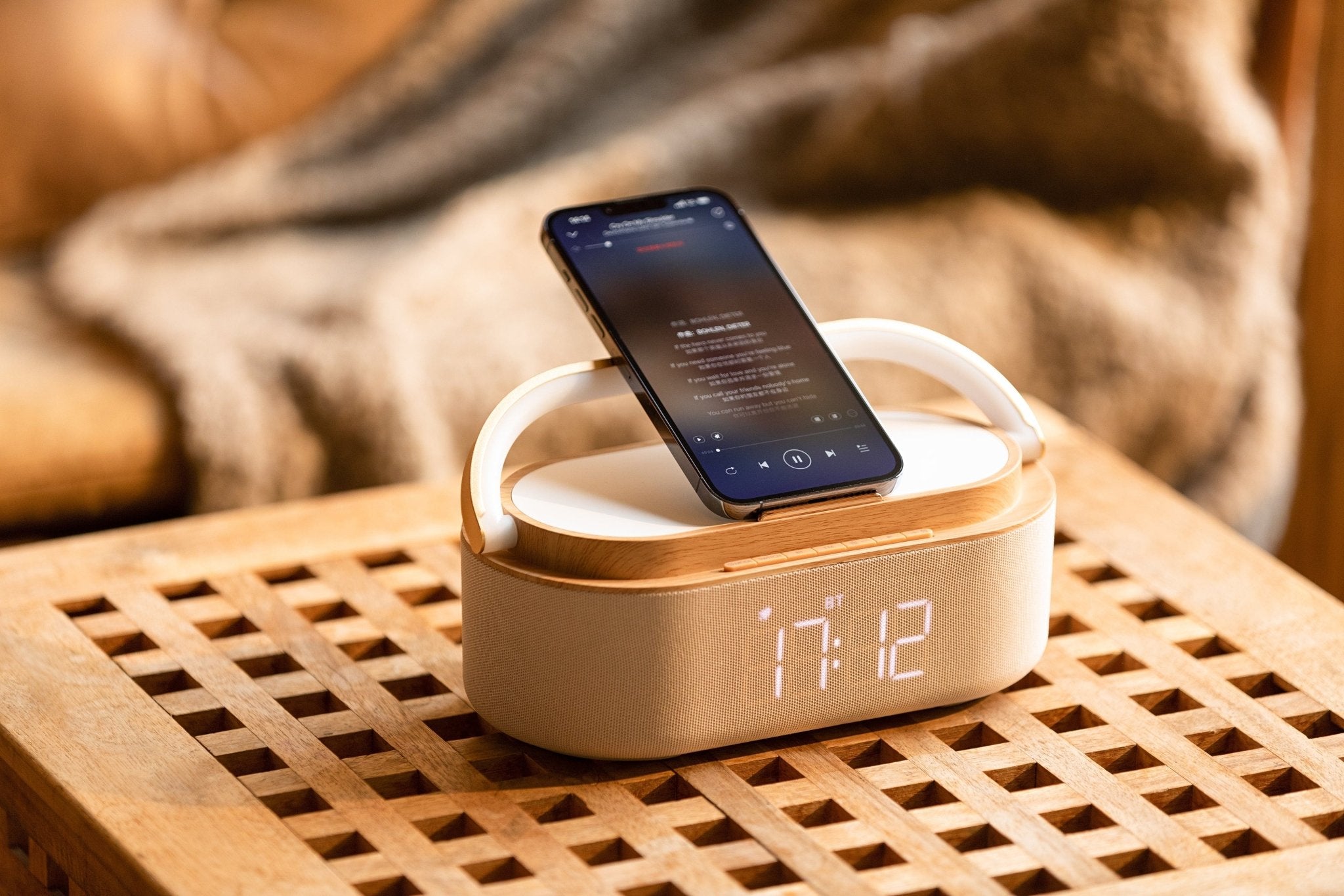 UK Technology Clock Radio Handle Lamp on a table with a phone in the upright position playing music via bluetooth