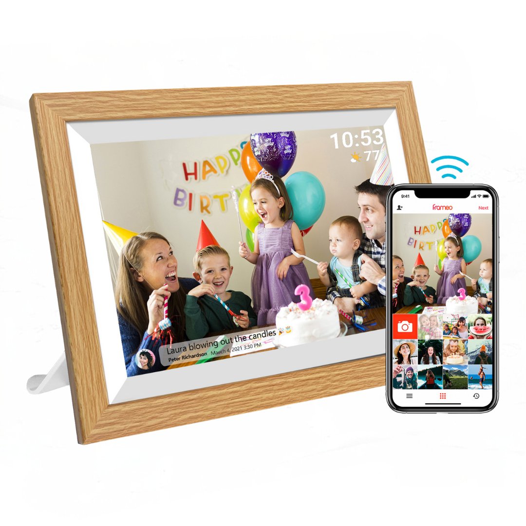 UK Technology Oak Wood Digital Photo Frame in landscape mode with a mobile phone showing the app connection