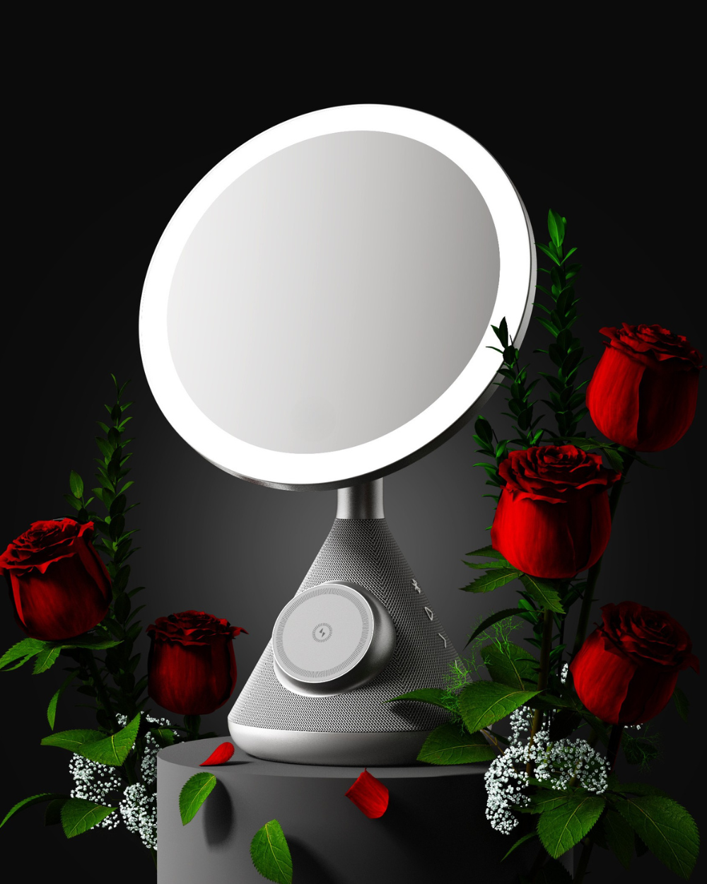 silver vanity mirror on a pedestal with roses surrounding it and highlighted by the white ring light